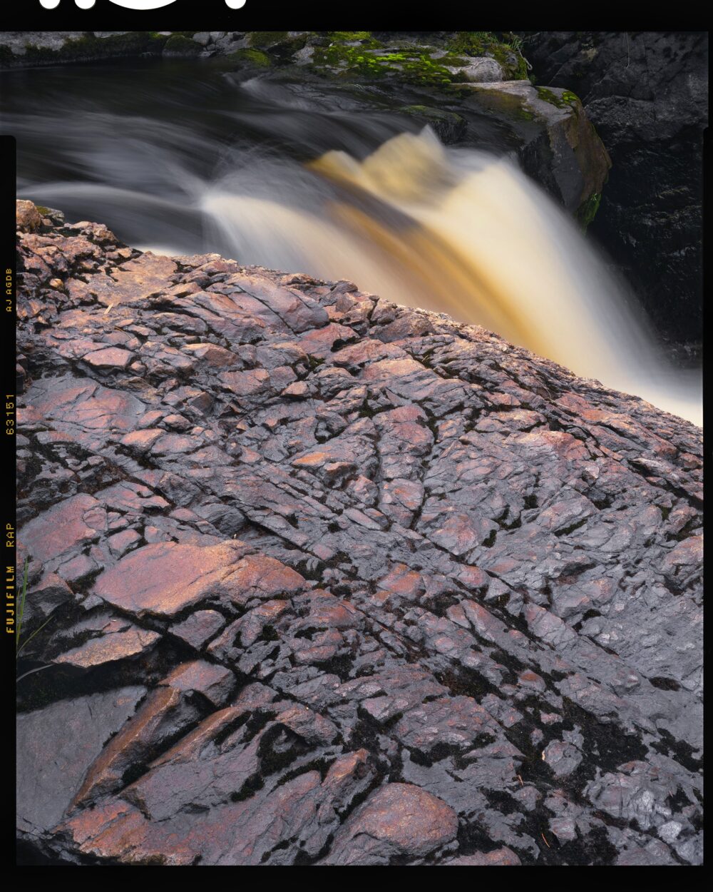 "Iron Ore Ledge and Cascade #4" is offered as a limited edition, fine art Color photographic print - Cisco Branch, Michigan Upper Peninsula.